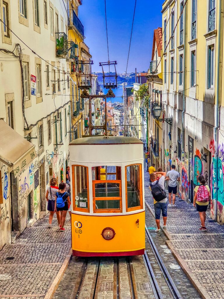 Colorful tram navigating the historic streets of Lisbon, capturing the urban vibrancy and steep gradients.