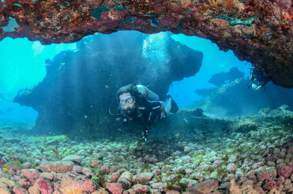 Experience thrilling scuba diving in the turquoise waters of Fernando de Noronha, revealing vibrant marine life and stunning rock formations.